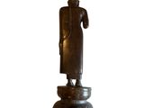 statue of a standing buddha on a pedestal on a white background