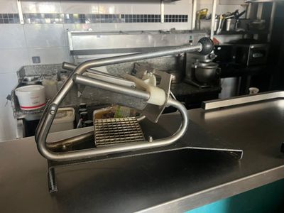 a large metal sink in a kitchen with a metal faucet