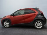a small red and black car parked in a parking lot