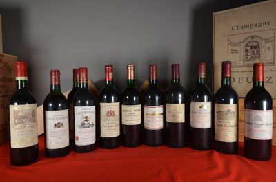 several bottles of wine are lined up on a table
