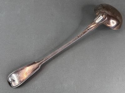silver spoon on a gray surface with a spoon in the middle of it
