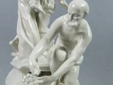 a statue of a man and a woman sitting on a rock