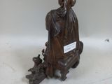 a statue of a woman sitting on top of a table