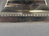 a close up of a silver plate with beads on it