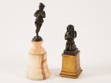pair of antique figurines of a man and a woman on marble bases