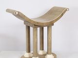 a wooden bench that is sitting on a white surface