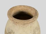 a large clay pot sitting on a white surface