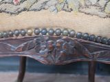 a close up of a chair that has a pillow on top of it