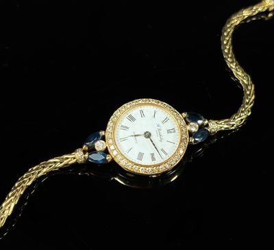 a close up of a watch on a chain with a chain around it