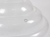 a white vase with a black lid on a white table