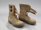 pair of brown boots with laces on them on a white surface