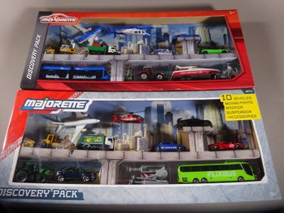 two toy vehicles in the box on the table