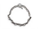 a close up of a chain bracelet on a white background