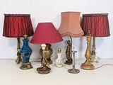 a lot of different lamps that are on a table