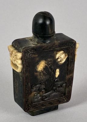 an old black and white box with a picture of a man on a horse