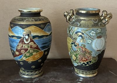 two vases sitting side by side on a table