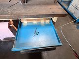 a table with a drawer on it in the middle of a room