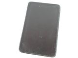 a small metal tray with a phone in it on a white surface