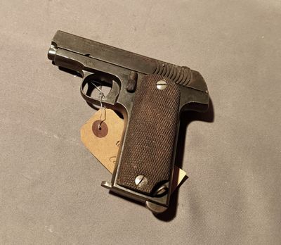a gun that is laying on a table with a tag