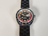 a black watch with a red face on a black strap