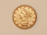 a gold coin with a woman ' s head on it