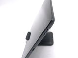 a close up of a laptop on a stand on a white surface