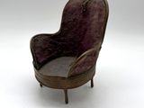 a miniature chair that is sitting on a white surface