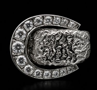 a close up of a silver ring with diamonds on a black background