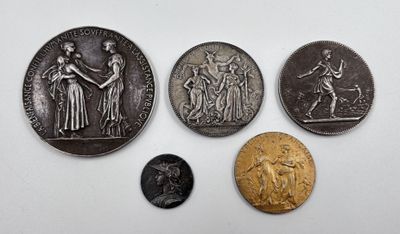 four different types of coins are shown on a white surface