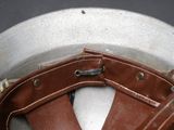 a close up of a helmet with a leather belt