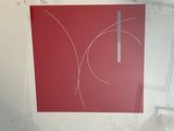 a picture of a red and white picture on the wall