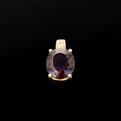 a close up of a purple stone ring on a black surface