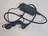 a close up of a black charger on a white surface