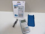 a calculator and a charger on a table