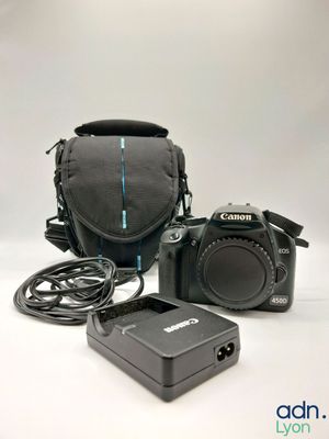 the camera is sitting next to the charger on the table