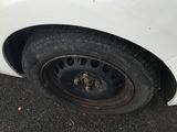 a white car that has a flat tire on it