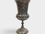 an image of a silver vase sitting on top of a table