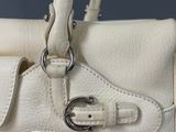 an image of a white handbag with a metal buckle