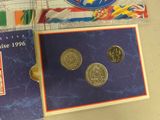 a lot of coins and a cd on a table