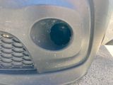 a close up of a car ' s front bumper with a hole in it