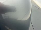 a close up of the wing of an airplane as it flies