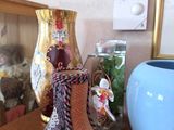 two vases sitting on a table next to a mirror