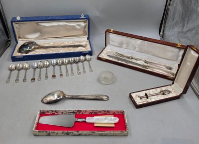 a table with silverware and silver spoons on it