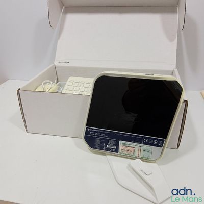 a box with a keyboard and a cell phone inside of it