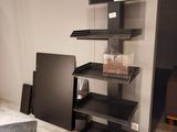 a black shelf that has a bunch of items on it