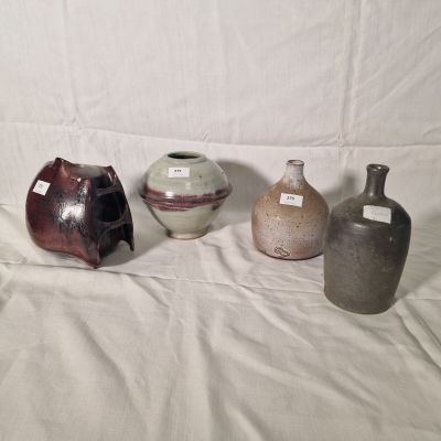 three vases are sitting on a white sheet with a white background