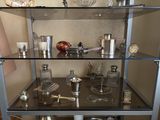a glass shelf with various items on it in a room