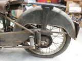a old motorcycle that is sitting in the garage