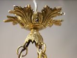 a gold candle holder with a bird on it