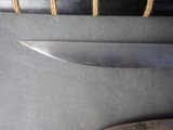 a knife on the table next to a knife on the table